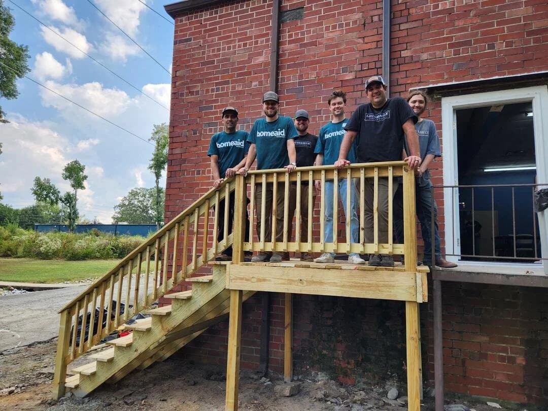Sherwin Loudermilk and team on a newly built deck at a HomeAid project